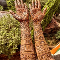 This full-arm bridal design showcases our expertise in traditional patterns. It features symmetrical layouts, royal arches, and fine-line details that cover the arms completely for a grand wedding look.