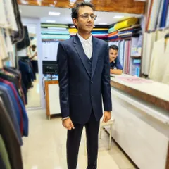 The final result. A groom looking confident and ready in his perfectly fitted, classic navy blue three-piece suit made from imported lustre fabric.