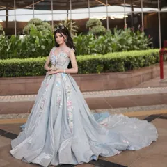 A dreamy, Disney-inspired glam look. The voluminous gown and sparkling makeup create a true fairytale moment.