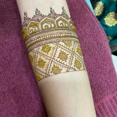This arm cuff features a parade of tiny elephants, a symbol of good luck and prosperity, requested by the bride.