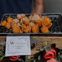 A close-up of our Waterchestnut Honey Chili starter. This Indo-Chinese favorite is crispy, sweet, and spicy, making it a popular choice for cocktail parties and sangeet nights.