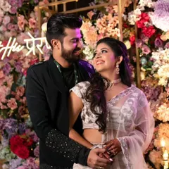 The look of love. This beautiful candid shot captures the joy between Prer and her partner, with her glowing makeup looking fresh and elegant against a stunning floral backdrop.