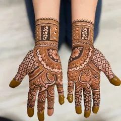 This full-hand design shows a rich, dark henna stain. The combination of floral mandalas and detailed finger work is a favorite among my clients.