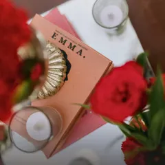 A thoughtful detail from an engagement party decor, where a copy of the classic novel "Emma" is used as a decorative element. This personal touch adds a layer of storytelling to the event.