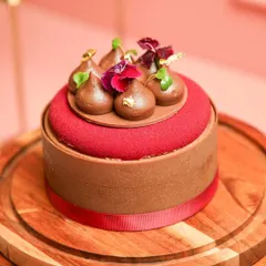 Our Chocolate Strawberry Entremet, a sophisticated dessert with rich chocolate, fresh strawberries, and a crunchy pistachio base.