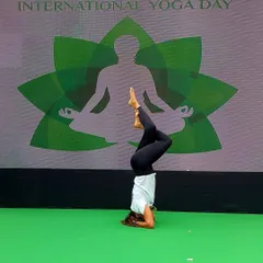 Demonstrating a variation of Sirsasana (headstand) on stage during the International Yoga Day event. My goal was to show that with practice, we can find stability and grace even when our world is turned upside down.