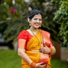 A beautiful solo portrait of the expecting mother from an outdoor shoot. Dressed in a traditional silk saree, her happiness and anticipation are radiant in the soft, natural light.