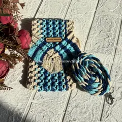 This blue and beige macrame mobile pouch is inspired by the colors of the sea. It's lightweight and just the right size for your phone and a few cards.