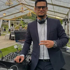 A quick pose behind the decks before the party gets started. I'm ready to bring the energy for your wedding celebration.