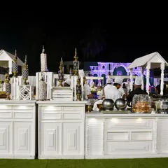 A clean and elegant all-white catering station. This setup is perfect for daytime events or white-themed parties, offering a fresh and sophisticated look for live cooking or buffet service.