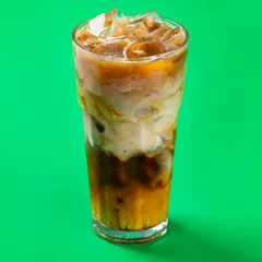 An iced coffee for Bistro by Blinkit, shot against a vibrant green background. This high-contrast style is perfect for digital billboards and online ads.