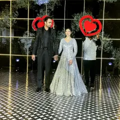 The final pose of the grand couple entry. The dancers with heart props frame the couple perfectly for a memorable photo.