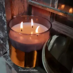 This is our beautiful 4x4 inch smoke glass jar with a metallic gold bottom and a premium metal lid. It's a 3-wick candle that lasts for days and gives a very classy, luxurious look.