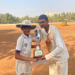 Two of our U-17 players proudly holding the MPL championship trophy on the field. Moments like these build confidence and team spirit.