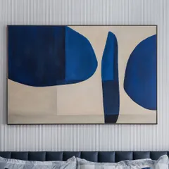 The power of abstract art. This bold, blue and beige painting acts as a stunning focal point above the bed, its geometric forms adding depth and intrigue against the vertically striped wall.