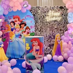 A classic Disney Princess birthday party. The setup features a backdrop with multiple princesses, a silver shimmer wall, and a custom-printed pedestal with Ariel.
