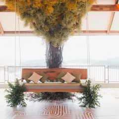 The centerpiece of the Bali-themed Haldi was this custom-made swing under a tree of baby's breath. It provided a stunning photo opportunity and a comfortable, stylish seat for the couple, overlooking the serene lake.