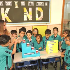 Our Headmistress engages with students as they explore the water purification experiment, encouraging their curiosity and answering their questions.