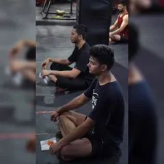 Members sitting in meditation after a workout. This practice is crucial for mental clarity and stress relief, helping you connect your mind and body.