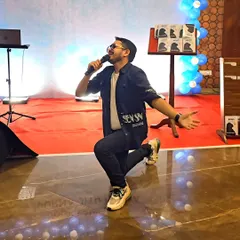 A shot of me in action, getting down on one knee to connect with the audience during a performance at a book launch.