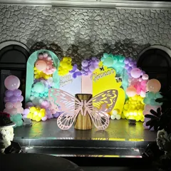 The full view of our enchanting butterfly party stage. The combination of pastel balloons, arched backdrops, and the central butterfly prop makes for a perfect cake-cutting ceremony.