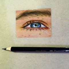 This hyper-realistic blue eye took almost three days to complete. I used Prismacolor pencils to create the freckles and the glossy reflection, making it look as real as possible.