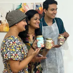 Guests at a baby shower proudly showing off the beautiful keepsake jars they decorated. It's a fun, interactive activity that leaves the parents-to-be with cherished mementos.