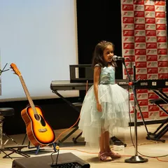 One of our youngest performers confidently takes the stage for a solo vocal performance at the Thane music showcase. We believe in nurturing talent from a young age and giving every student their moment in the spotlight.