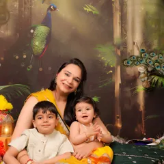 A beautiful family portrait from a Janmashtami-themed shoot. The mother and her two children are dressed in vibrant traditional wear, creating a colorful and culturally rich memory.