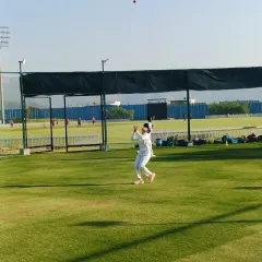 Eyes on the ball. A young cricketer positions himself perfectly under a high ball during a catching drill, demonstrating the focus and technique we instill in our players.