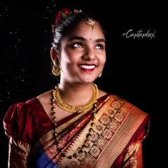 A joyful and elegant portrait capturing the beauty of a traditional Marathi look. I use a classic black background and specific lighting techniques to make the rich colors of the saree and the intricate gold jewelry stand out.
