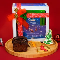 Our Christmas gift hampers are curated to deliver joy. This beautifully packaged 'Merry' hamper includes our classic plum cake, festive cookies, and other treats, making it the perfect holiday gift for friends and family.
