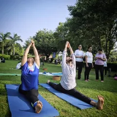 Two students practicing Hanumanasana (splits) side-by-side during our "One Earth, One Health" outdoor event.