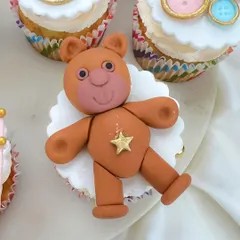 Look at this cute, handcrafted fondant teddy bear topper. It's these little details that make our custom cupcakes a memorable part of your celebration.