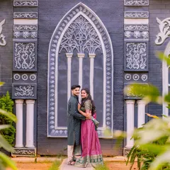 A stylish portrait in front of a unique, gothic-style architectural feature. This backdrop adds a touch of drama and sophistication to the photo.