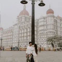 A classic pre-wedding portrait in front of the Taj Mahal Palace Hotel. The historic lamp post adds a touch of old-world charm to this iconic Mumbai location.