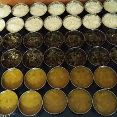 Preparing lunch orders for offices in Greater Noida. We ensure every meal, whether for home or office, is prepared with the same attention to hygiene and homemade taste. Here you can see bhindi sabzi, dal, and rice ready to be packed.