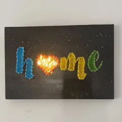 A closer look at my "Home" string art piece with the fairy lights turned on. The glowing heart creates such a warm and inviting ambiance.