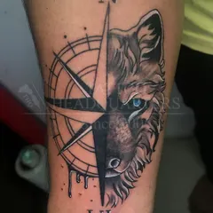 This wolf and compass piece is an example of our black and grey realism work. We focus on capturing sharp details and creating a design that has both meaning and impact.
