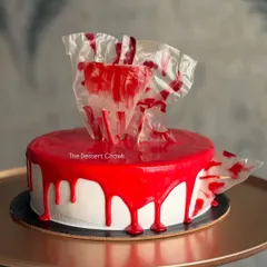 A modern and artistic take on the chocolate truffle cake, with a glossy red glaze and abstract chocolate shard topper.
