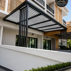 For this project, we created a cantilevered carport with a louvered roof that integrates directly into the building's facade. The black powder-coated steel structure provides a sharp, modern contrast against the home's exterior, demonstrating how a carport can be a seamless architectural extension.