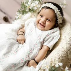 The pure, unfiltered joy of a baby's smile. This photo is a beautiful reminder of the happiness a new baby brings into a family.