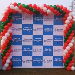 We designed this backdrop for a corporate sports event. The setup features a custom printed backdrop with the event's branding, framed by a balloon arch in the event's colours.