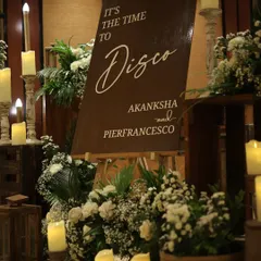 We set the mood for this cocktail night with a chic welcome sign that read "It's the time to Disco." The sign was surrounded by arrangements of white flowers and dozens of candles, creating a warm and inviting entrance.
