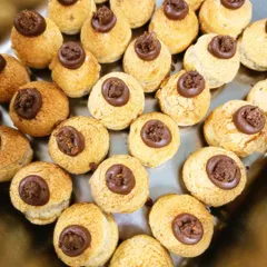 A tray of our artisanal choux pastries, filled with a rich chocolate cream. These were part of a large Diwali catering order and are one of my favorite things to make.