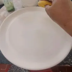 The journey of a hand painted plate begins with a clean, blank canvas. This is a stoneware plate that I have shaped and smoothed, ready for its design. Every beautiful piece starts with this simple, humble step.