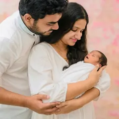 A slightly different angle showing the parents' loving embrace around their sleeping newborn. My goal is to provide a variety of beautiful shots from your first family session.