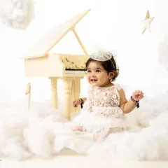 A heavenly smile from this little angel. The "piano in the clouds" setup is one of my most requested for sitter and milestone sessions.