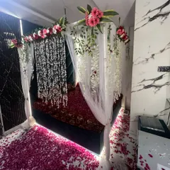 The complete wedding night room setup, creating a luxurious and romantic retreat for the couple with flowers and soft lighting.