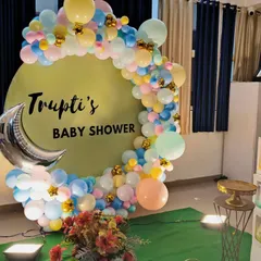 We create dreamy baby showers, like this one for Trupti. This setup includes a custom circular backdrop, a beautiful organic balloon arch in soft pastel colors, and a silver moon foil accent, creating a perfect photo opportunity.